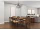 Spacious dining room with hardwood floors, modern chandelier, and a view of the living area at 2027 Trident Maple Ln, Chapel Hill, NC 27517