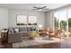 Cozy living room with comfortable seating, ceiling fan and a sliding glass door to the balcony at 2027 Trident Maple Ln, Chapel Hill, NC 27517