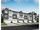 View of new townhouses from the street with garages and neutral-color siding at 2027 Trident Maple Ln, Chapel Hill, NC 27517