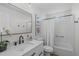 Bright bathroom featuring a white vanity with marble countertop and a bathtub with shower at 211 Fleming Dr, Durham, NC 27712