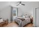 Cozy bedroom with a ceiling fan, light-filled window and wood-look flooring at 211 Fleming Dr, Durham, NC 27712