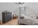 Cozy bedroom with a ceiling fan, dresser, and light-filled window with light-blue curtains at 211 Fleming Dr, Durham, NC 27712