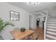 Stylish dining room showcasing a wood table, black chairs, and a staircase view at 211 Fleming Dr, Durham, NC 27712
