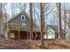 A beautiful house exterior features a spacious deck, large garage and wooded setting at 211 Fleming Dr, Durham, NC 27712