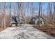 Property featuring a cottage-style home with detached garage and ample driveway space at 211 Fleming Dr, Durham, NC 27712