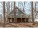 Charming home exterior featuring a spacious deck, exposed lower level and wooded setting at 211 Fleming Dr, Durham, NC 27712