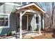 Covered front porch with stylish lighting, rain chains, and well-manicured landscaping at 211 Fleming Dr, Durham, NC 27712