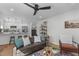 Inviting living room featuring a comfortable leather sofa, stylish decor, and an open connection to the kitchen at 211 Fleming Dr, Durham, NC 27712