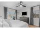 Serene main bedroom featuring a king-size bed, a gray dresser, and a sliding door to a deck at 211 Fleming Dr, Durham, NC 27712