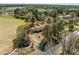 Overhead view of home surrounded by mature trees, near fields and paved road at 2125 W Academy St, Holly Springs, NC 27540