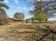 Brick home on a large lot, with mature trees and a view of the back yard at 2125 W Academy St, Holly Springs, NC 27540