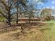 Spacious backyard with mature trees and a view of the home's brick exterior at 2125 W Academy St, Holly Springs, NC 27540