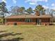 Brick house with a screened porch and a large backyard, perfect for outdoor enjoyment at 2125 W Academy St, Holly Springs, NC 27540