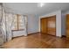 Bedroom with wood floors, closet and window with curtains at 2125 W Academy St, Holly Springs, NC 27540