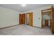 Large bedroom with carpet, two closets, and an attached bathroom at 2125 W Academy St, Holly Springs, NC 27540