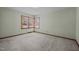 Bedroom with carpeted floors and natural light from large window at 2125 W Academy St, Holly Springs, NC 27540