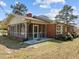 Side view of a brick home featuring a screened-in porch at 2125 W Academy St, Holly Springs, NC 27540