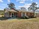 Classic brick ranch home with screened porch, mature landscaping, and inviting curb appeal at 2125 W Academy St, Holly Springs, NC 27540