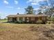 Charming brick ranch home with a screened-in porch and mature trees in a spacious yard at 2125 W Academy St, Holly Springs, NC 27540