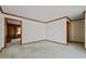 Hallway featuring wood-paneled walls, wallpaper accents, and connecting doorways for a functional layout at 2125 W Academy St, Holly Springs, NC 27540