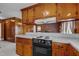 This kitchen features wooden cabinets and countertops with a view to a living room fireplace at 2125 W Academy St, Holly Springs, NC 27540