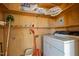 Laundry room with plywood walls, storage shelving, and vintage washer at 2125 W Academy St, Holly Springs, NC 27540