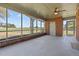 Enclosed porch with brick walls, ceiling fan, and views of the adjacent open field at 2125 W Academy St, Holly Springs, NC 27540