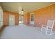 Enclosed brick porch with brick walls, ceiling fan, and rocking chair at 2125 W Academy St, Holly Springs, NC 27540