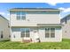 Backyard view featuring outdoor seating area and lush green grass, perfect for relaxation and enjoying the outdoors at 2177 Campbell, Burlington, NC 27215