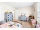 This bedroom boasts ample storage with blue dressers, complemented by the soft carpet, and the colorful quilt on the twin bed at 2177 Campbell, Burlington, NC 27215