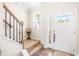Inviting entryway featuring a white front door, stairs, and natural light from the window at 2177 Campbell, Burlington, NC 27215