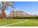 Majestic estate with a sprawling green lawn, beautiful landscaping, and elegant architectural details at 2177 Campbell, Burlington, NC 27215
