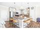 Bright kitchen with a large center island, granite countertops, stainless appliances, and four woven bar stools at 2177 Campbell, Burlington, NC 27215