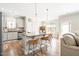 Open kitchen with a large island, bar stool seating, stainless steel appliances, and hardwood floors at 2177 Campbell, Burlington, NC 27215