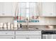 Close up of the kitchen sink and decor featuring granite countertops, and white cabinets at 2177 Campbell, Burlington, NC 27215