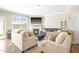 Cozy living room with a fireplace, large windows, comfortable seating, and neutral decor at 2177 Campbell, Burlington, NC 27215