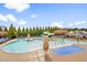 Aerial view of a community pool featuring a waterslide, splash area and sun umbrellas at 2177 Campbell, Burlington, NC 27215