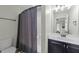 Bathroom featuring a toilet, shower with curtain and vanity with mirror and light fixture at 2310 Gilman St, Durham, NC 27703