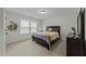 Cozy bedroom featuring neutral walls, carpet floors, a dark wood queen bed, and natural light from a window at 2310 Gilman St, Durham, NC 27703