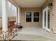 Covered patio space with a bench seating area and access to the backyard at 2310 Gilman St, Durham, NC 27703