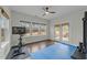 Bright home gym with a large window, blue exercise mat, stationary bike and access to an outdoor patio at 2310 Gilman St, Durham, NC 27703