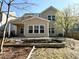 Back of home with covered patio and well landscaped yard with flowering tree at 2310 Gilman St, Durham, NC 27703