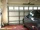 View of the garage with painted floor, storage, and an electric car at 2310 Gilman St, Durham, NC 27703