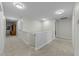 Spacious hallway with neutral color palette and carpet flooring with access to multiple rooms on the second floor at 2310 Gilman St, Durham, NC 27703