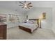Bedroom with vaulted ceilings and a ceiling fan, with soft carpeting, large window and Queen bed at 2310 Gilman St, Durham, NC 27703