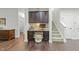 A built-in desk area features dark wood cabinets and drawers, complemented by a woven stool and hardwood floors at 2310 Gilman St, Durham, NC 27703