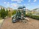 Community playground with slides and climbing structures, surrounded by trees and mulch at 2310 Gilman St, Durham, NC 27703