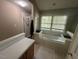 Bright bathroom featuring a soaking tub with jets, and a glass shower at 27 Creeks Edge Ct, Durham, NC 27713