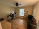 Neutral bedroom featuring hardwood floors, ceiling fan, and natural light at 27 Creeks Edge Ct, Durham, NC 27713
