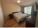 Bedroom with wood floors, a ceiling fan, and a large window at 27 Creeks Edge Ct, Durham, NC 27713